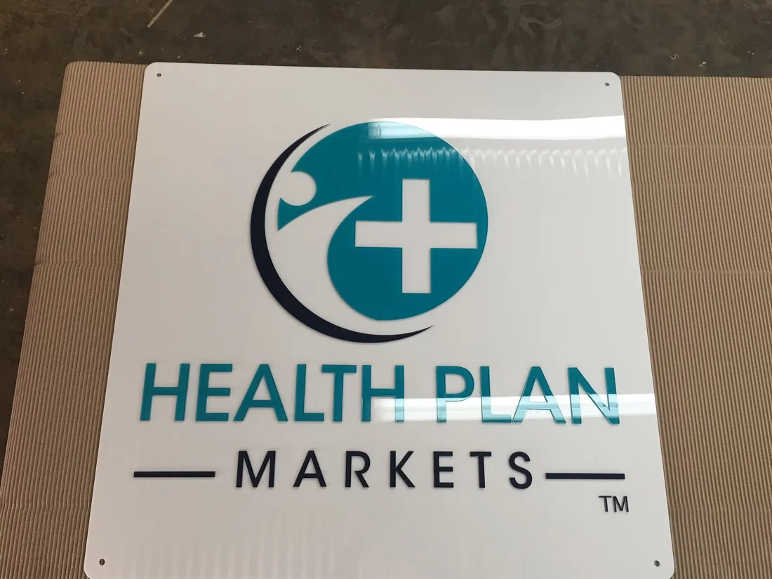 Project 56: Health Plan Markets — clean dimensional logo sign.