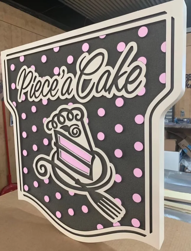 Piece of Cake — custom hanging logo sign.