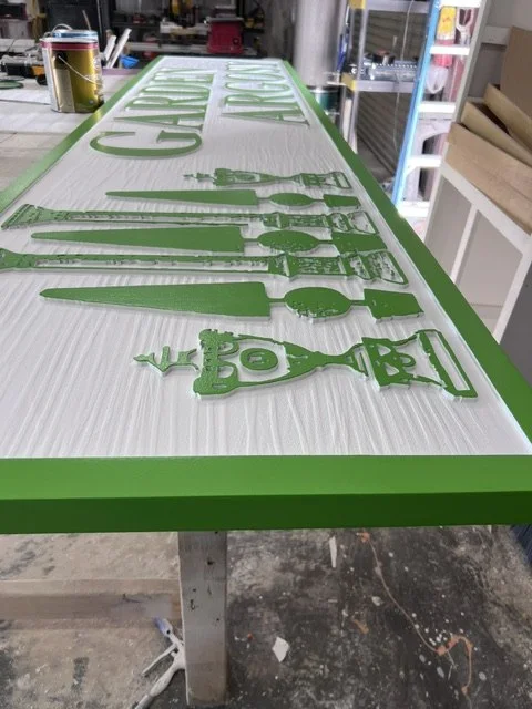 Project 112: Garden Argosy — close view of routed details, raised lettering and dimensional garden graphics.
