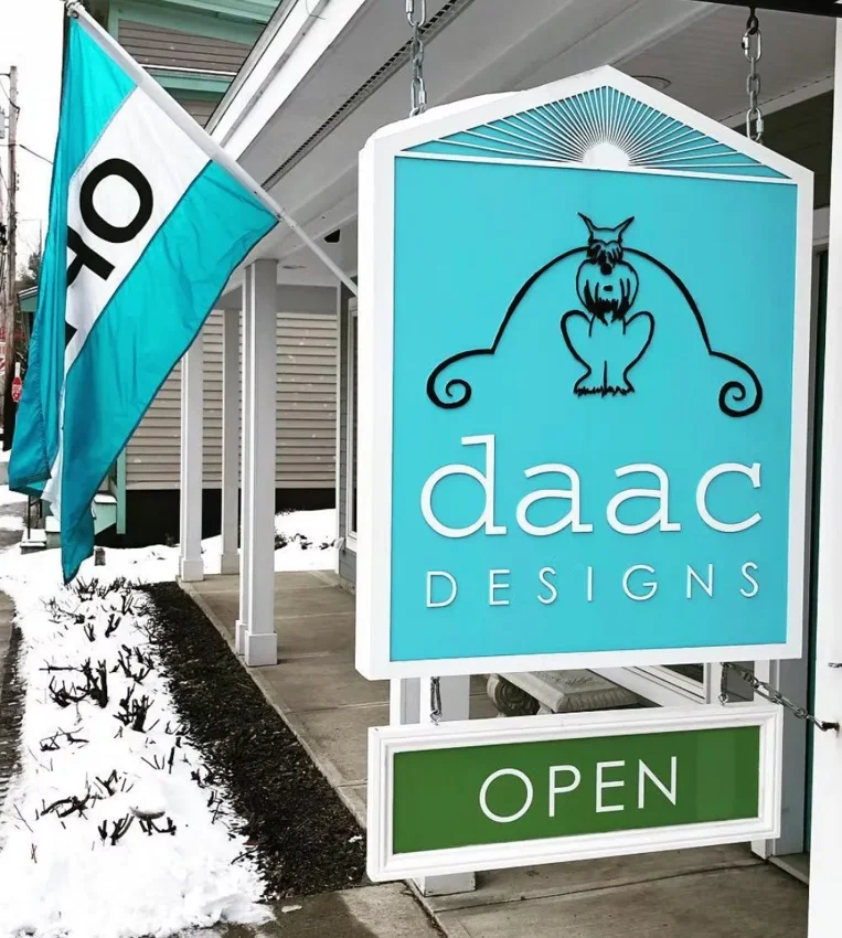 Project 44: DAAC Designs — custom hanging storefront sign with open panel.