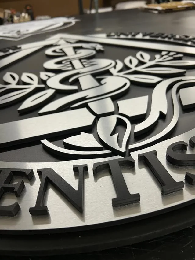 Project 127: Layered black and white logo parts prepared for assembly.