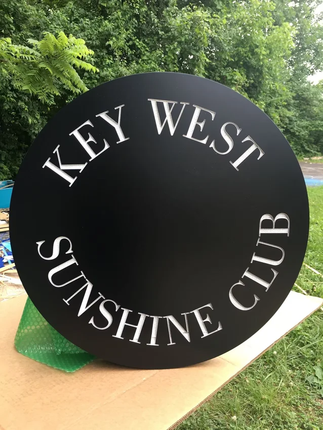 Project 46: Key West Sunshine Club — round club sign with dimensional lettering.