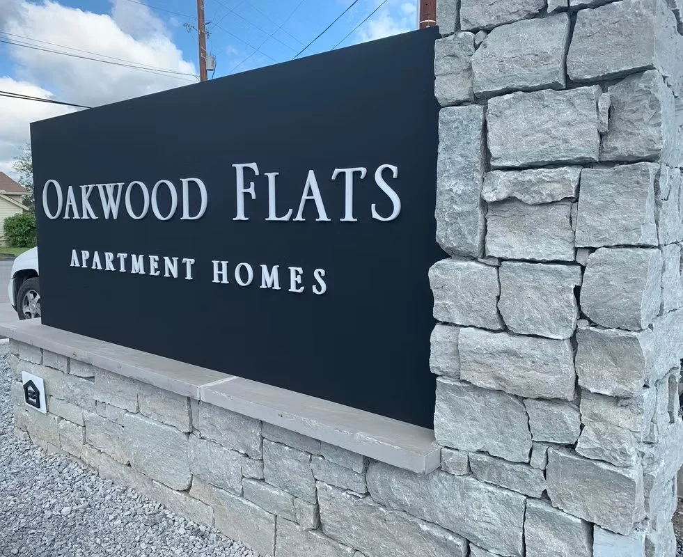 Oakwood Flats Apartment Homes — installed monument sign face.