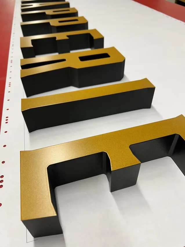 Black and gold dimensional letter set showing layered side depth