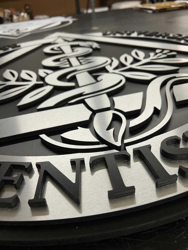 Black and white layered logo components with dimensional detail