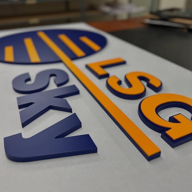 Blue and orange dimensional letters arranged for assembly