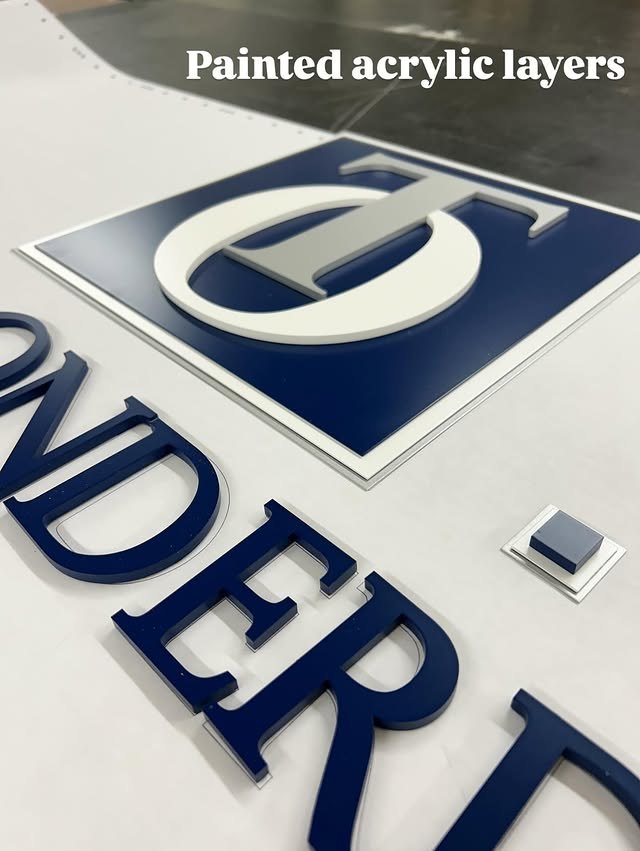Blue and white painted acrylic layers with raised lettering