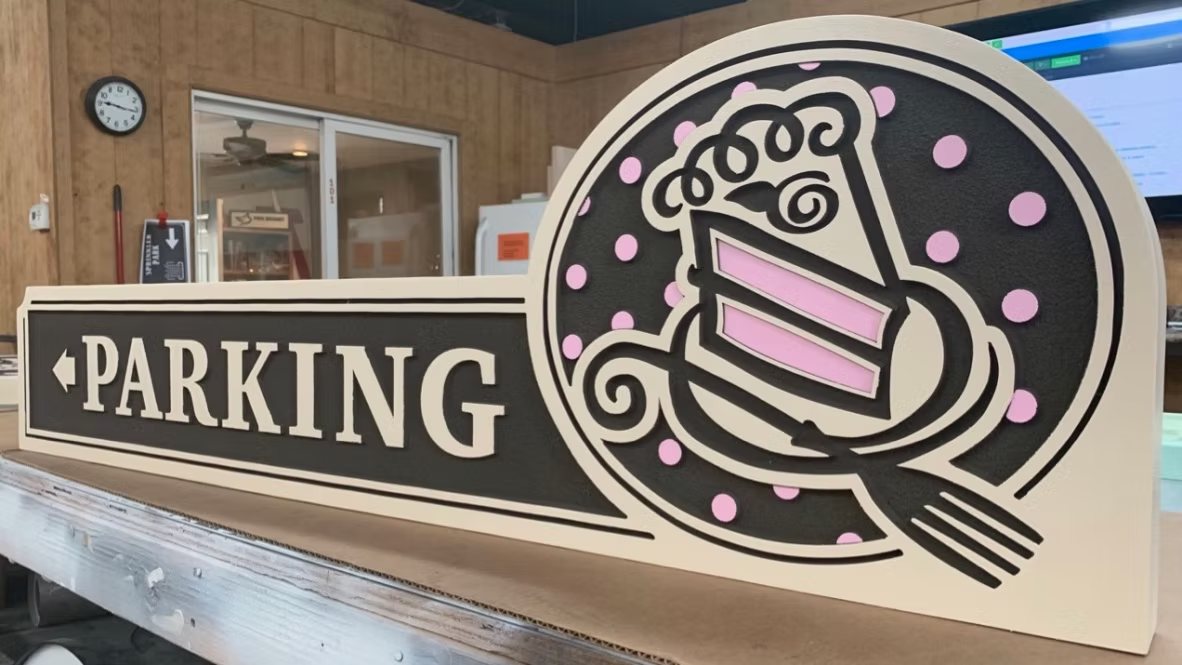 Piece of Cake parking directional sign
