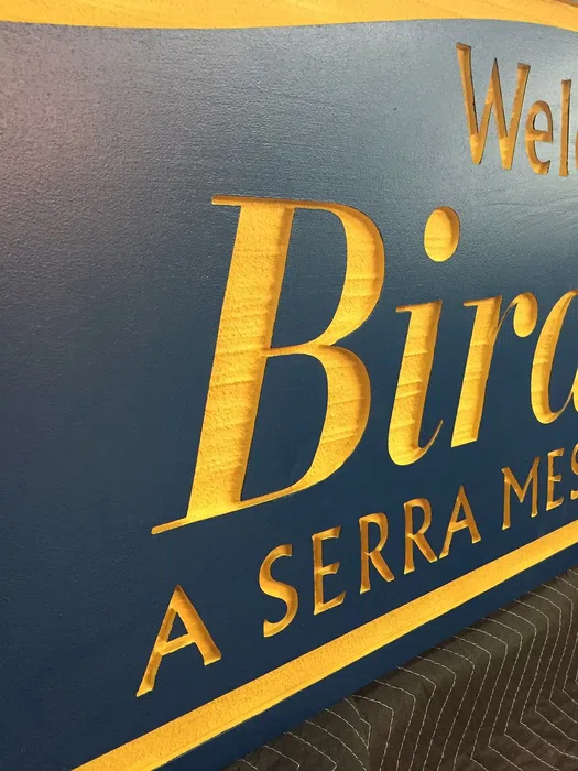 Close view of raised gold lettering on Birdland sign