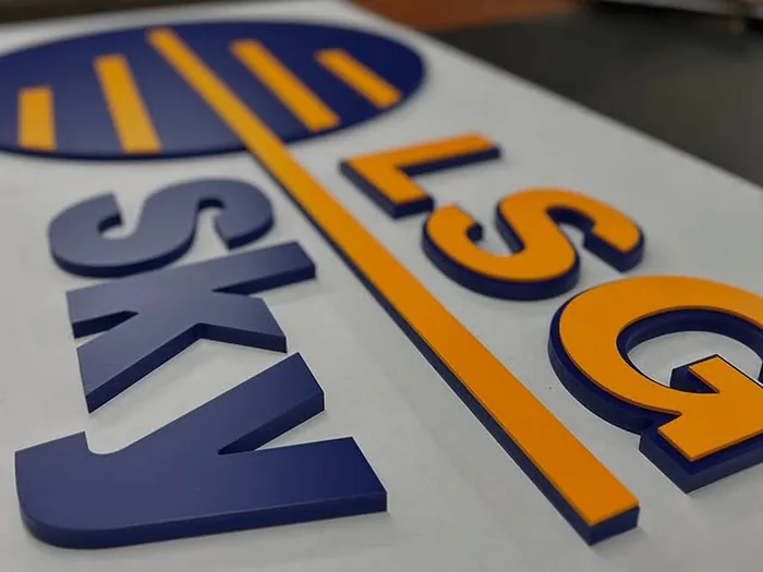 Blue and orange dimensional letters arranged for assembly