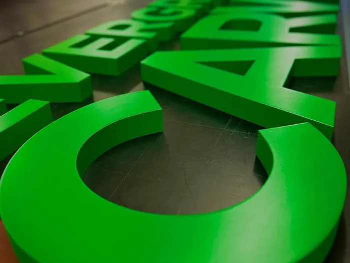 Bright green dimensional letters showing routed edges and depth