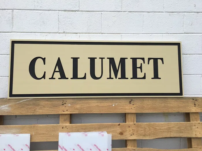 Cream and black Calumet office sign