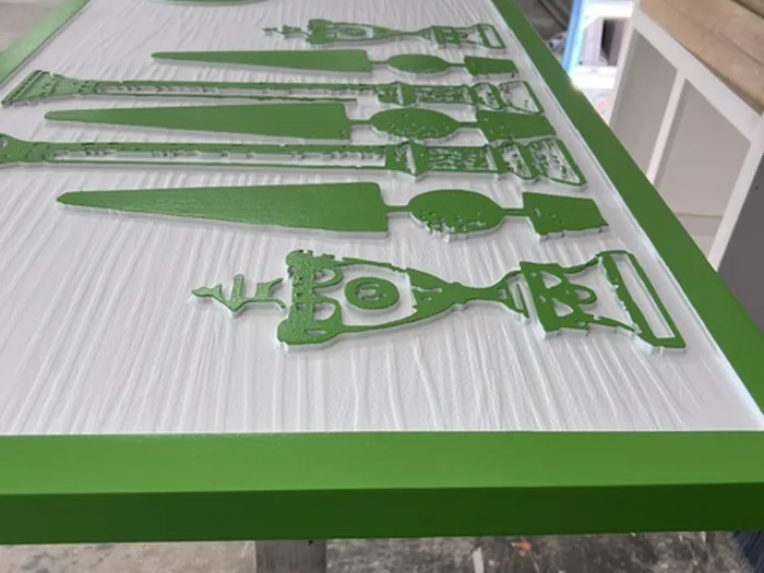 Close view of Garden Argosy sign with raised green letters and garden graphics