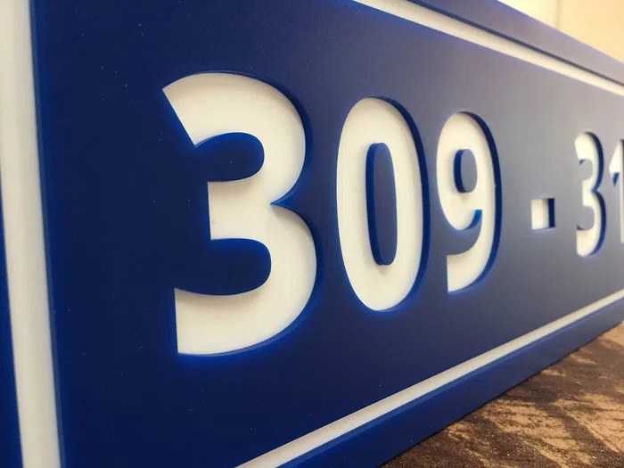 Illuminated blue address number sign