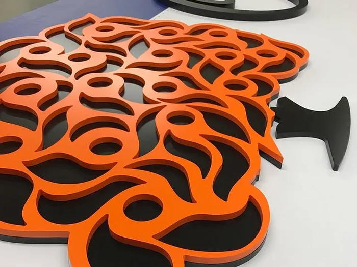 Orange and black layered tree logo fabricated from acrylic