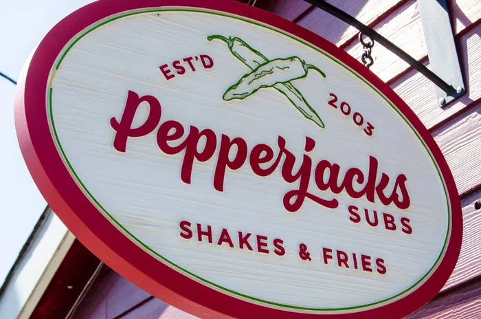 Oval Pepperjacks Subs hanging sign