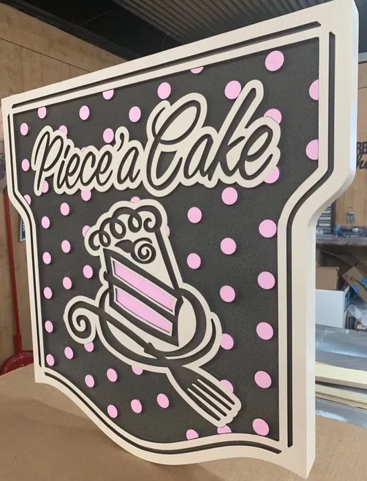Pink and black Piece of Cake hanging logo sign