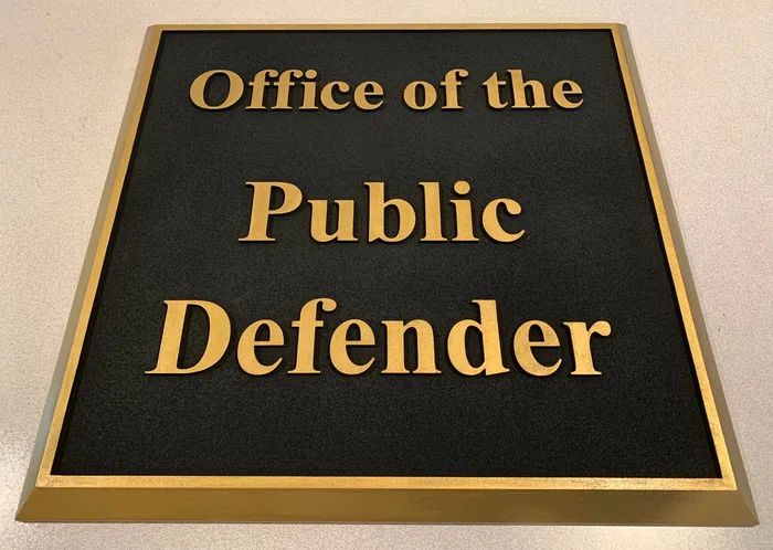 Black and gold Office of the Public Defender plaque sign
