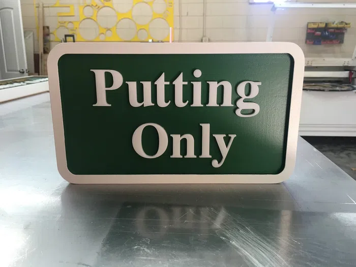Green and white Putting Only golf course sign