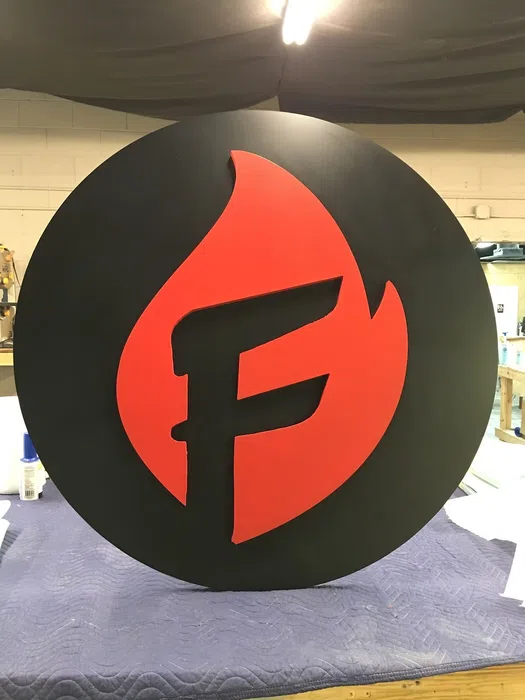 Round red and black dimensional letter F logo sign