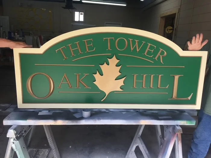 Green and cream The Tower at Oak Hill dimensional sign with oak tree graphic