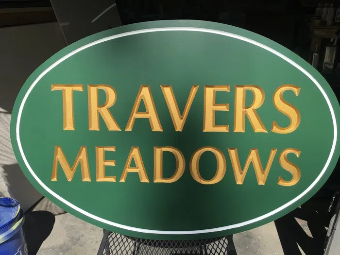 Green oval Travers Meadows property sign
